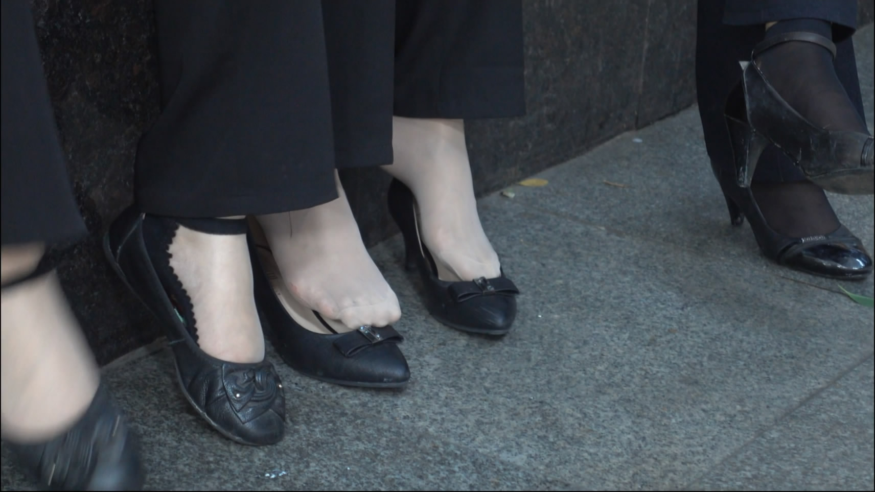 Beautiful girl playing shoes at the edge of the park